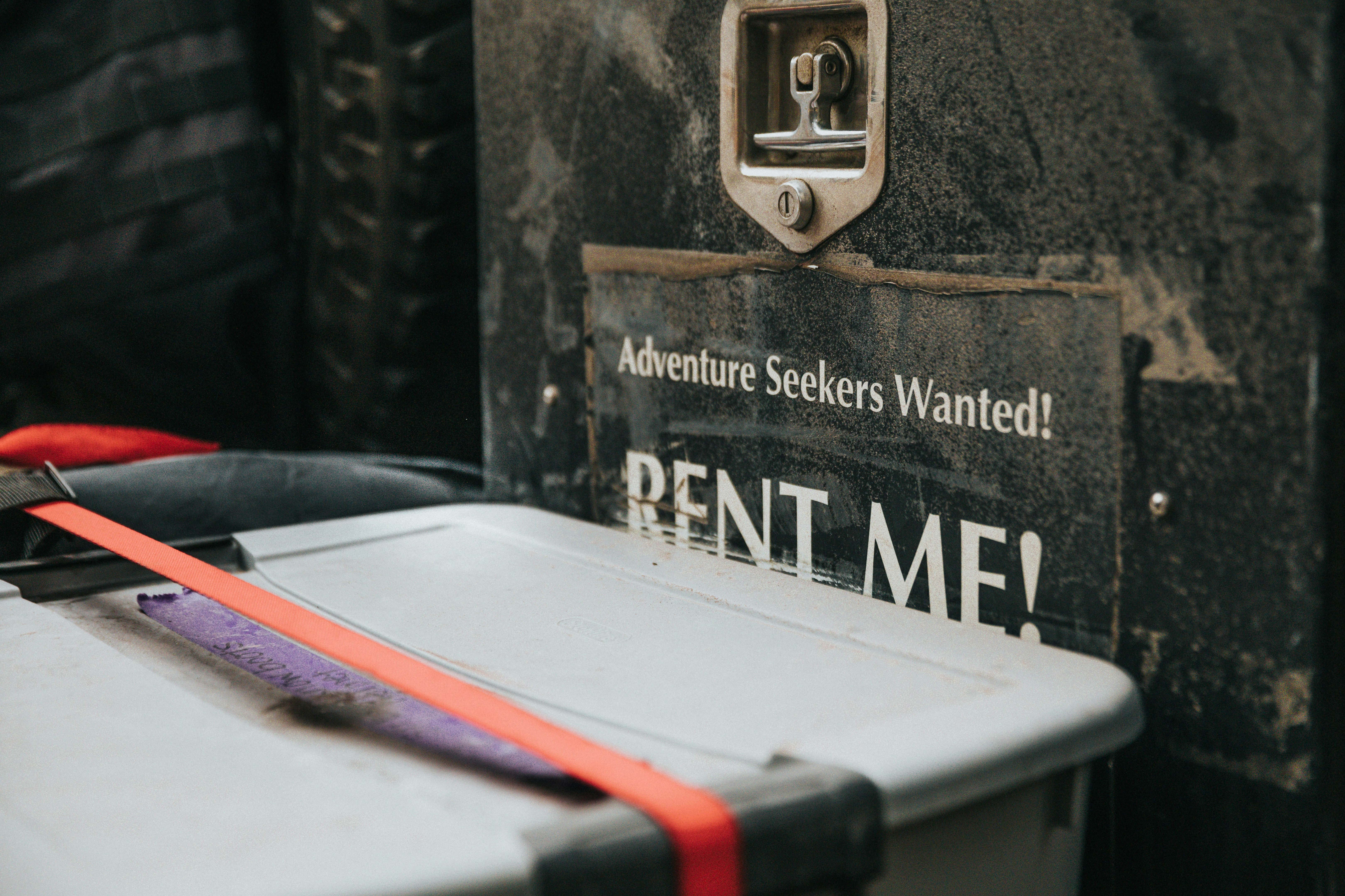 white plastic container beside rent me signage